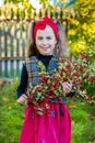 A branch of hawthorn in the hands of a cute girl in the garden. Royalty Free Stock Photo