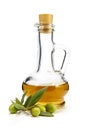 A branch of olive and olive oil in a decanter on a white backgro