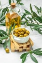 Branch with olives and a bottle of olive oil on white background. top view. place for text Royalty Free Stock Photo