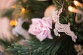 Christmas tree toys and a deer on a branch of an artificial Christmas tree.