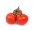 A branch of three ripe tomatoes on a white background.  Twig. Close up. Juicy ripe vegetables. Royalty Free Stock Photo