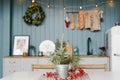 Branches ate in a metal vase on the kitchen table, decorated for Christmas Royalty Free Stock Photo