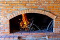 Branches are burning inside fireplace made of bricks Royalty Free Stock Photo
