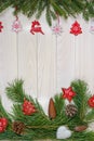 Branches of a Christmas tree, New Year`s decor on a light wooden background. Close-up, vertical shot. Design for postcards, banner Royalty Free Stock Photo