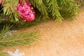 The branches of Christmas trees and fallal cone decorations on the background of wooden boards.
