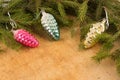 The branches of Christmas trees and fallal cone decorations on the background of wooden boards. Royalty Free Stock Photo