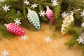 The branches of Christmas trees and fallal cone decorations on the background of wooden boards and snowflakes.