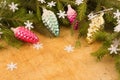 The branches of Christmas trees and fallal cone decorations on the background of wooden boards and snowflakes.