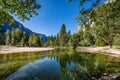 Branches from the top in the foreground of Merced River looking towards half dome in Yosemite National Park