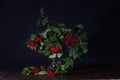 Branches of red viburnum in a glass vase stand on a table Royalty Free Stock Photo