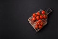 Branches of ripe red cherry tomatoes with salt and spices Royalty Free Stock Photo