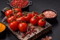 Branches of ripe red cherry tomatoes with salt and spices Royalty Free Stock Photo