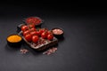 Branches of ripe red cherry tomatoes with salt and spices Royalty Free Stock Photo