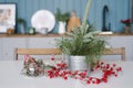 Branches of spruce or pine in a metal bucket stands on the kitchen table, decorated for Christmas Royalty Free Stock Photo