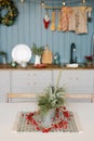 Branches of spruce or pine in a metal decorative bucket on the kitchen table, decorated for Christmas Royalty Free Stock Photo