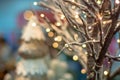 Branches of a tree braided with a luminous garland. Shallow depth of field Royalty Free Stock Photo