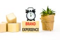 Brand experience symbol. Concept words Brand experience on wooden blocks. Beautiful white table white background. Black alarm