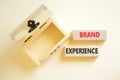 Brand experience symbol. Concept words Brand experience on wooden blocks. Beautiful white table white background. Wooden empthy