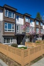 Brand new apartment building on sunny day in spring with blooming trees in British Columbia, Canada. Royalty Free Stock Photo