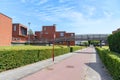 Brand new brick houses along a bicycle path on a clear summer day