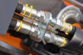 Brand new hydraulic couplers and hoses, on a piece of orange farming machinery