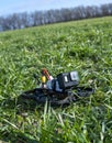 A Brand-New Modern Cinewhoop Iflight Protek 35 with GoPro Action Camera on Board Outdoors in the Grass