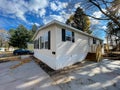 Brand new prefab mobile home with for sale yard sign post, colorful fall foliage near Rochester, New York Royalty Free Stock Photo