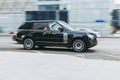 Brand new Range Rover L405 side view. Sport SUV black color driving against a background of glass building. Full size luxury