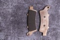 Brand new rose gold colored metal motorcycle brake pads with ferodo on a gray surface Royalty Free Stock Photo