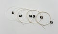 Brand-new set of nylon and metal-wound strings for classical guitar, isolated on white Royalty Free Stock Photo