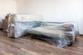 Brand new sofa on a wooden floor during the reconstruction Royalty Free Stock Photo