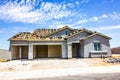 Brand New Stucco Home Under Construction With Three Car Garage Royalty Free Stock Photo