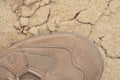 Brand new suede and nylon beige tan camo military tactical desert combat boot, arid dried soil and sand, horizontal background