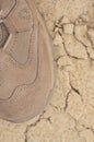 Brand new suede and nylon beige tan camo military tactical desert combat boot, arid dried soil sand, detailed vertical background