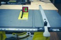 Brand-new table saw with digital level box inclinometer showing 0-degree angle attaches to steel blade and aluminum fence