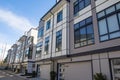 Brand new townhouse complex. Rows of townhomes side by side. External facade of a row of colorful modern urban townhouses. brand n Royalty Free Stock Photo