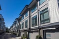 Brand new townhouse complex. Rows of townhomes side by side. External facade of a row of colorful modern urban townhouses. brand n