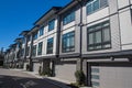 Brand new townhouse complex. Rows of townhomes side by side. External facade of a row of colorful modern urban townhouses. brand n Royalty Free Stock Photo