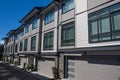 Brand new townhouse complex. Rows of townhomes side by side. External facade of a row of colorful modern urban townhouses. brand n Royalty Free Stock Photo