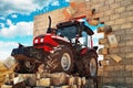 Brand new Tractor breaking through the wall Royalty Free Stock Photo