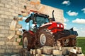 Brand new Tractor breaking through the wall Royalty Free Stock Photo
