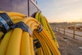 Rolls of plastic and rubber pipes and tubes laid against a wall inside a housing construction site Royalty Free Stock Photo