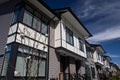 Brand new upscale townhomes in a Canadian neighbourhood. External facade of a row of colorful modern urban townhouses.brand new ho Royalty Free Stock Photo