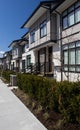 Brand new upscale townhomes in a Canadian neighbourhood. External facade of a row of colorful modern urban townhouses.brand new ho Royalty Free Stock Photo