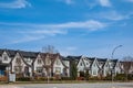 Brand new upscale townhomes in a Canadian neighbourhood. External facade of a row of modern urban townhouses Royalty Free Stock Photo