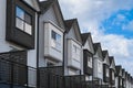 Brand new upscale townhomes in neighbourhood. Nice development of townhouses. External facade of a row of modern houses Royalty Free Stock Photo