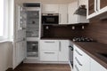 A brand new white kitchen with white panels and open empty fridge Royalty Free Stock Photo