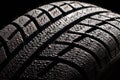 Brand new winter tire pattern on black background Royalty Free Stock Photo