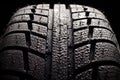 Brand new winter tire pattern on black background Royalty Free Stock Photo