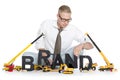 Brand start up: Businessman building brand-word.